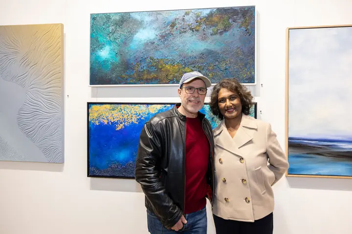 Visitors in front of a framed work