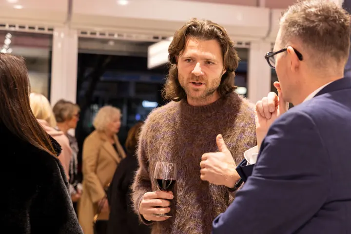 Guests talking over a drink