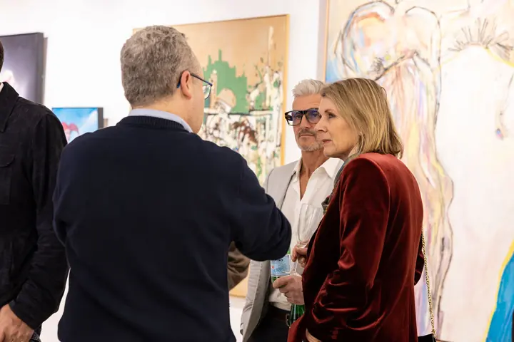 Visitors viewing a large canvas